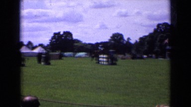1963: Horses Jumping Hurdles at Competition as White Clad Spectators Look On