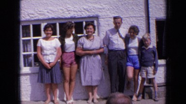 1963: happy family is posing for snap before house ENGLAND