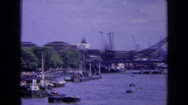 1963: panoramic view of london bridge and cranes lined up along thames. ENGLAND