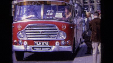 1963: red color bus in ylk carrying passengers in stop ENGLAND