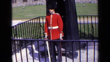 1963: royal british guard stands like statue at his post, guarding castle