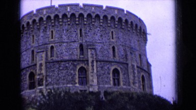 1963: Huge Stone Tower with Arched Doors Standing on Hill in England