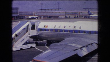 1963: slow pan along length of sabena airplane's exterior at airport FRANCE