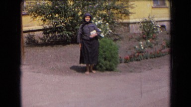 1963: the woman was standing near plants and smiling FRANCE