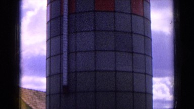 1963: showing very old buildings with people's standing in side
