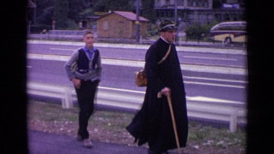 1962: man and children walking on path alongside highway. SWITZERLAND