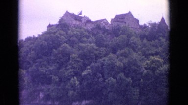 1962: Rushing Waterfall Overlooked by Castle atop Wooded Plateau SWITZERLAND