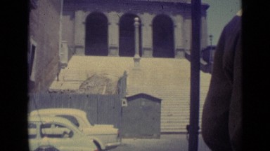 1962: white stone steps reaching up to old building with three large archways