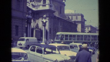 1962: people walking on busy street as automobiles roll by in road. VATICAN CITY