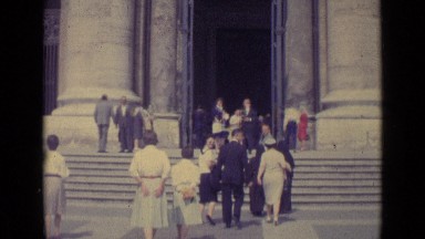 1962: visitors fill city plaza and approach steps leading to dark interior