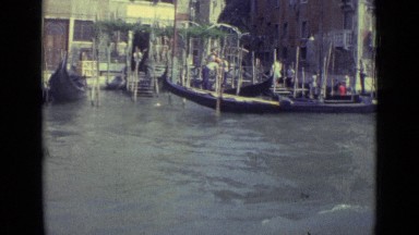 1962: man rowing country boat along shore of river VENICE ITALY