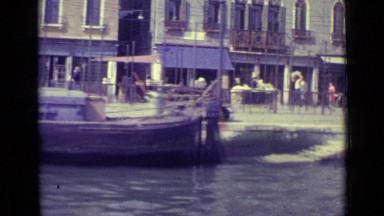 1962: moving along waterway passing various boats, gondolas, and people on land
