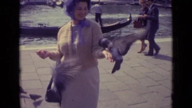 1962: woman feeding pigeons from her hand VENICE ITALY