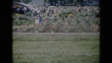 1961: group of people, mostly women, walking across field or farm land MISSOURI