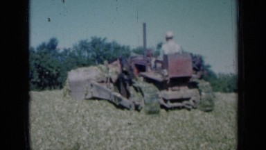 1961: man on bulldozer, spreading fertiliser on plantation MISSOURI