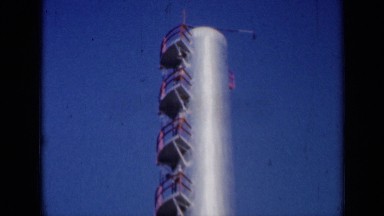 1961: people standing at foot of chimney high up in sky MISSOURI