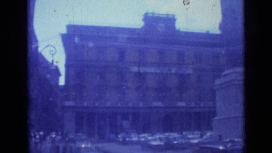 1962: area of city with lot of skyscrapers where people moving