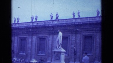 1962: view of large building with elaborate stone work and carvings and people