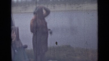 1962: Woman in Dress Sets Picnic Meal Along Riverside in Russia