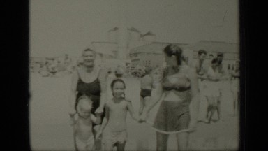 1949: children and their mother playing in seashore NEW YORK