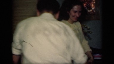 1949: man, woman, and two young girls form circle while holding hands