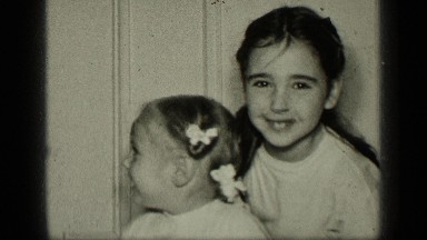 1957: older girl playing with younger girl NEW YORK