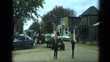 1959: the two boys are walking on road with tractor ALEDO TEXAS