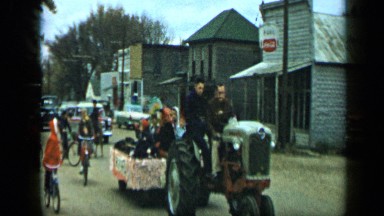 1959: people moving on different types of vehicles along street ALEDO TEXAS