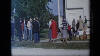1959: many people standing near to street where car approaches ALEDO TEXAS