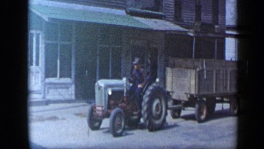 1959: men minding their own business and driving their vehicles across city.