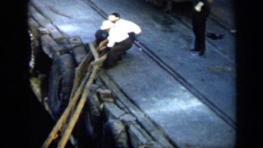1959: men haul huge rope to dock at port VENEZUELA