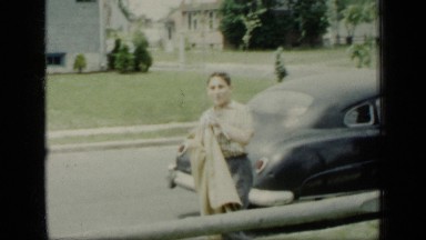 1948: the boy was walking on road, and putting shirt NEW YORK