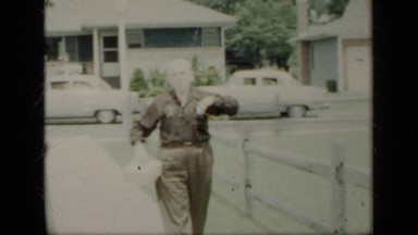 1948: the old man walking on street, taking out some thing