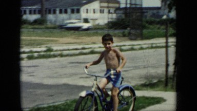 1948: the boy was cycling on road with smiling, cycle. NEW YORK