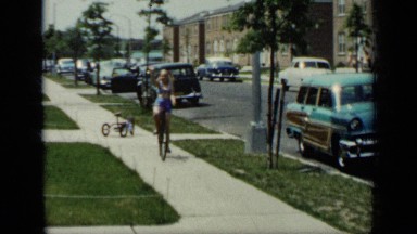 1948: girl happy to drive cycle on platform of road NEW YORK
