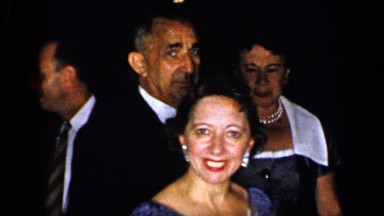 1948: happy middle-aged folks congregate at formal get together. NEW YORK