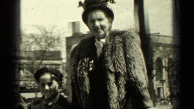 1949: very tall well dressed women walking down street with young boy