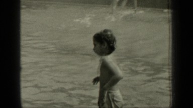 1949: childrens are bathing in river, they are running and enjoying day.