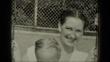 1949: child swinging with mother in garden NEW YORK