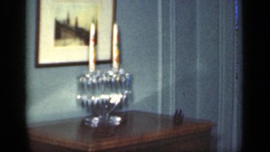 1949: an old man sitting in room with lot of painting and sculptures around