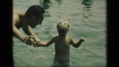 1949: father and son play in water NEW YORK