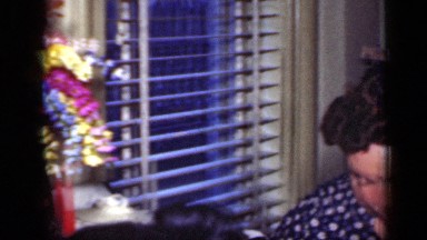 1949: white women and white man seated at inside table smiling and eating