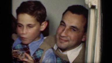 1949: three children and two adults sharing meal time of fried chicken. NEW YORK