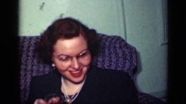 1949: two white women seated on sofa with another older woman speaking