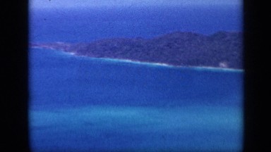 1959: very beautiful mountainous scenery with very blue ocean and lot of trees