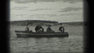 1939: people are travelling in a boat LONG LAKE CANADA