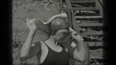 1939: woman with a swimming cap wrapping a towel around her shoulders LONG LAKE