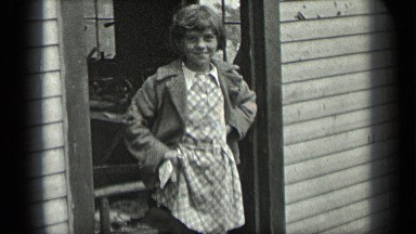 1939: a girl looking the goose and the goose searching food for them