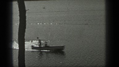 1939: people are travelling in a boat LONG LAKE CANADA