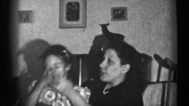 1947: woman playing with little girls hair on her lap ILLINOIS
